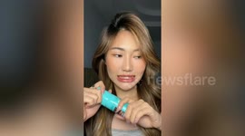 Thai woman uses brown-coloured hairspray to add fake freckles on face