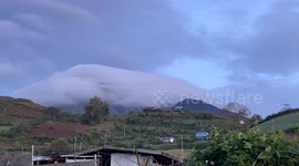 Volcano has his hat on as spectacular clouds form around peak