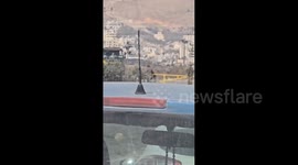 Israeli forces shut down with a metal bar the entrance to the town of Beit Furik in the West Bank