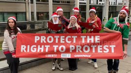 Activists sing Christmas carols outside the Home Office in support of the right to protest