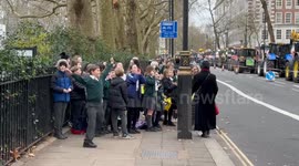 School children cheer on farmers tractor protest in London