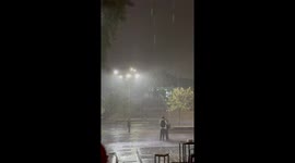 Lovers Kiss In Pouring Rain