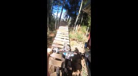 Mountain biker falls off narrow wooden plank bridge in Gorbea, Chile