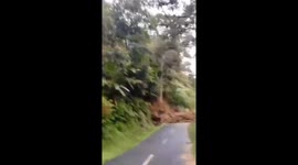 Landslide crashes onto roads during storms in Indonesia