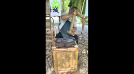 Craftsman works on traditional bamboo chair in China