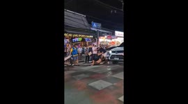 Two drunk tourists fight in front of bar in Phuket