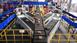China: Workers work on a parcel sorting line at an express logistics company in Qingzhou