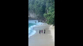 Beachgoer knocked over by wave while trying to make video with friends
