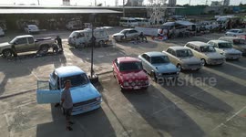 Dozens of vintage cars lined up at motor show