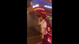 Reveller hits arcade punch bag but falls into board