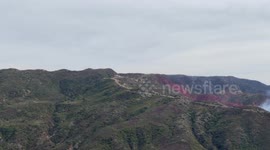 Firefighting plane drops red retardant on Franklin Fire in Malibu