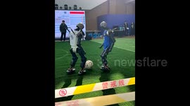 Robo-chop! Robots attempt to play football in China but end falling over themselves