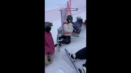 Man gives out barbecue on a snowy mountain in Xinjiang, China