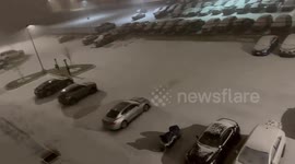 Snowfall covers parking lot in Buffalo, New York, USA
