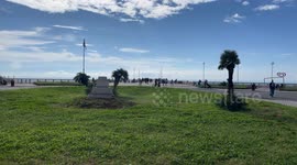 A panoramic view of the green flowerbed at the entrance to the Ostia pier on a sunny Sunday in October in Rome.