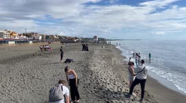 People on the beach of Lido di Ostia on a peaceful Sunday in October in Rome.