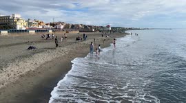 People on the beach of Lido di Ostia on a peaceful Sunday in October in Rome.
