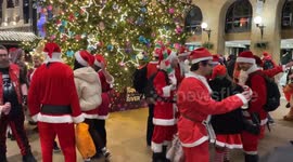 Dozens of revellers dressed as Santa Claus gathered at Hay's Galleria in London for this year's SantaCon