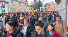 A large sign featuring Giorgia Meloni and Benito Mussolini kissing among people during the protest march against the security decree organized by the Rete No DDL Sicurezza (no security decree law network) in Rome.