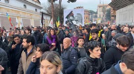 A large sign featuring Giorgia Meloni and Benito Mussolini kissing among people during the protest march against the security decree organized by the Rete No DDL Sicurezza (no security decree law network) in Rome.