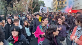 A large sign featuring Giorgia Meloni and Benito Mussolini kissing among people during the protest march against the security decree organized by the Rete No DDL Sicurezza (no security decree law network) in Rome.