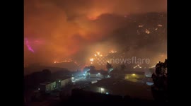 Night and morning after the wildfire in Malibu, California, USA