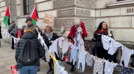 Children's clothes hanging on strings at Rally for Palestine in London symbolise children killed in Gaza