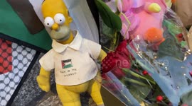 People lay children's toys and flowers outside Downing Street in London during a Rally for Palestine