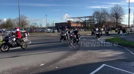 100s of bikers some in Christmas costumes travel in convoy to deliver donated toys to charity in Derbyshire UK