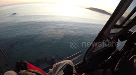 Helicopter rescues two trapped by high tide in California