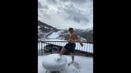 Person accidentally hits table while kicking snow off in Madrid, Spain