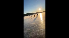 Rescuers form human chain to rescue woman and child from frozen lake in Chelyabinsk, Russia