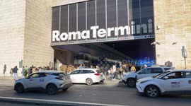 Taxis park in front of one of the entrance points to Rome Termini Station.