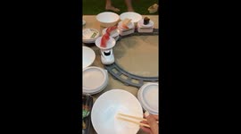 Family makes DIY sushi conveyor belt with train set