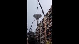Crane arm snaps sending water tank crashing to ground in China