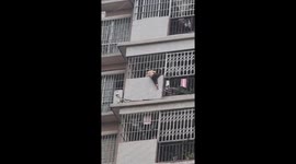 Hero neighbour rescues toddler climbing from eighth floor balcony in China