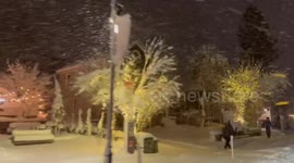 Snow covers homes as Christmas lights glow in Truckee, California