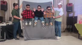 Colleagues perform humanette dance for office party