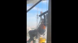 High-rise window cleaner appears outside 30fth floor office
