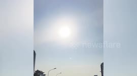 Rare double-sided sun halo filmed above city buildings