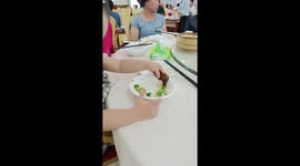 Toddler uses duck’s head to pick up broccoli from plate