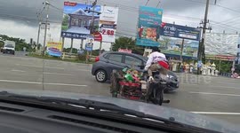 Motorcycle rider does yoga poses while travelling on road