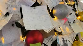 A wish card bearing the words ‘Free Palestine from Tunisia’ was hung among other wish cards on the decorated Christmas tree installed at Termini Station during the Christmas season in Rome.