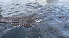 Some plastic and polystyrene waste floats on the water along the canal port in Fiumicino.