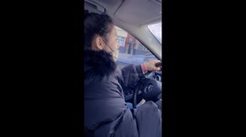 Driver carefully navigates snowy windshield in Liaoning, China