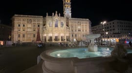 In the foreground, the fountain in Piazza Santa Maria Maggiore, illuminated in the evening, restored for the Jubilee and in the background the Papal Basilica of Santa Maria Maggiore in Rome.