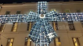 Gian Christmas bow on the facade of Chanel's flagship store magically lights up Bond Street in London