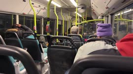 The interior of an old polluting bus on the road with some commuters returning home after work in the evening in Rome.