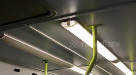 An interior light bulb of an old polluting bus vibrates during the journey in Rome.