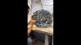Artist carves hyper realistic grapes from stone